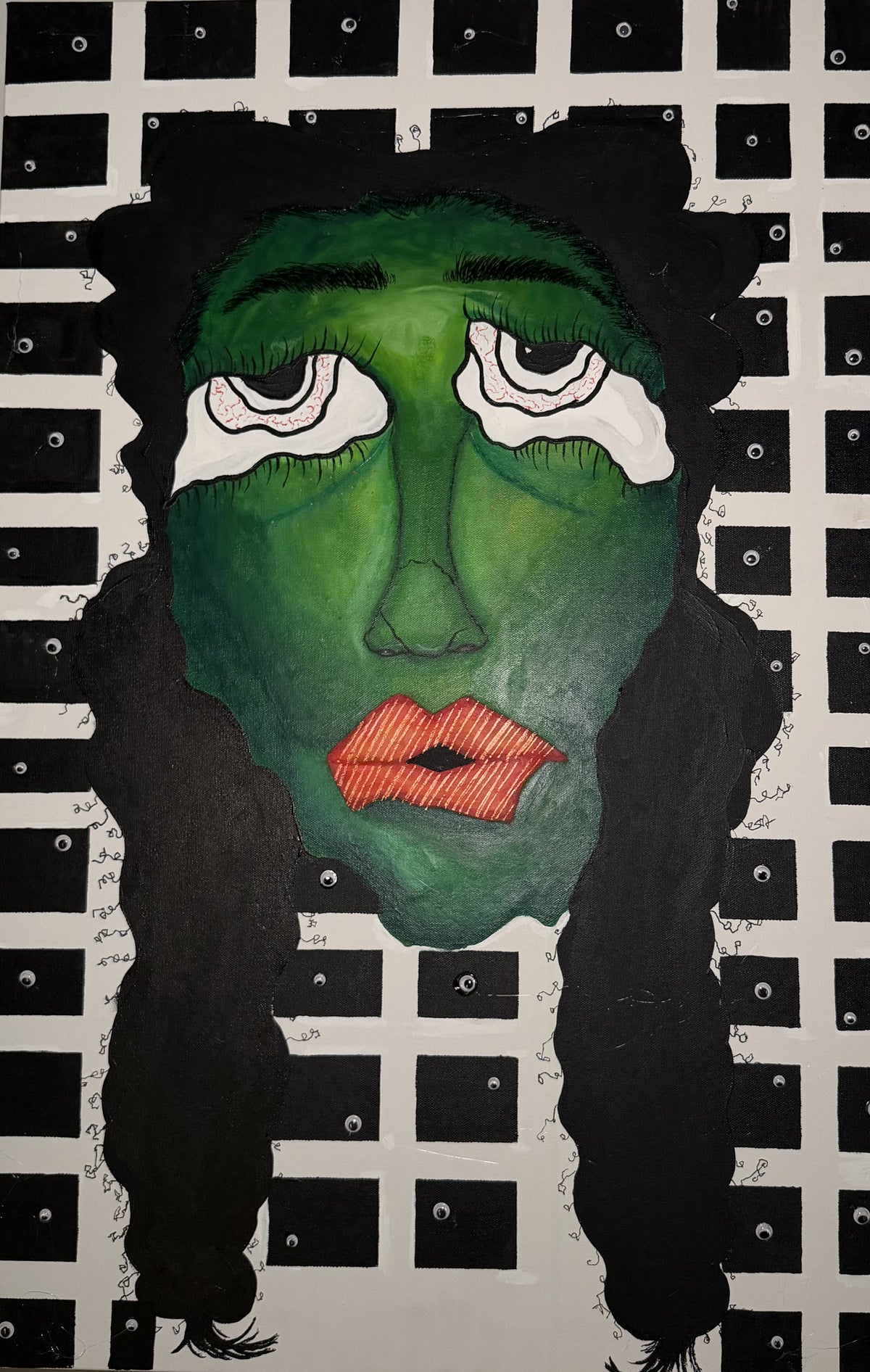 A stylized portrait artwork of a face with a green skin tone, black hair, white tear-like eye shapes, and red lips, set against a black-and-white grid background with small circular details.