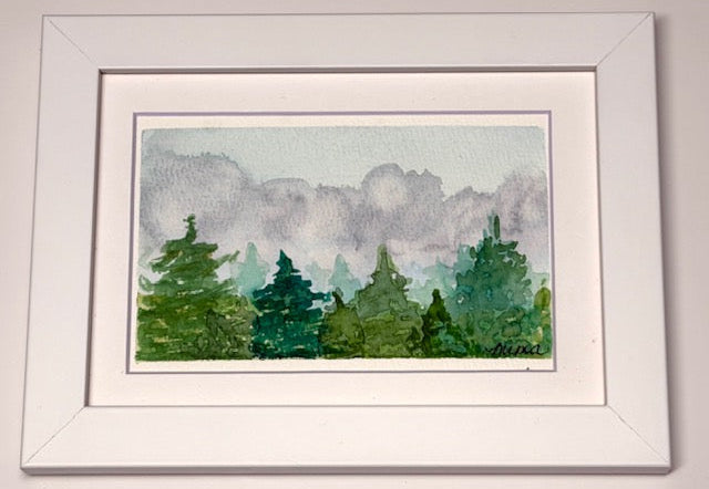 Framed watercolor painting of trees with a gray sky