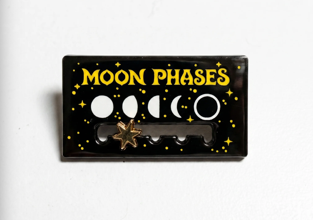 Moon phases enamel pin on a white background