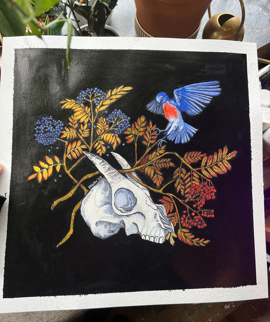 Artistic depiction of a bird, skull, and floral elements on a dark background