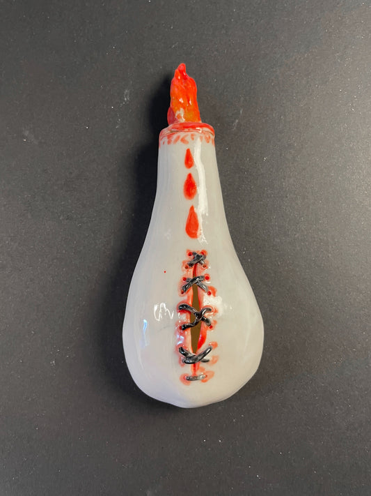 Decorative piece with red and black designs on a dark gray background