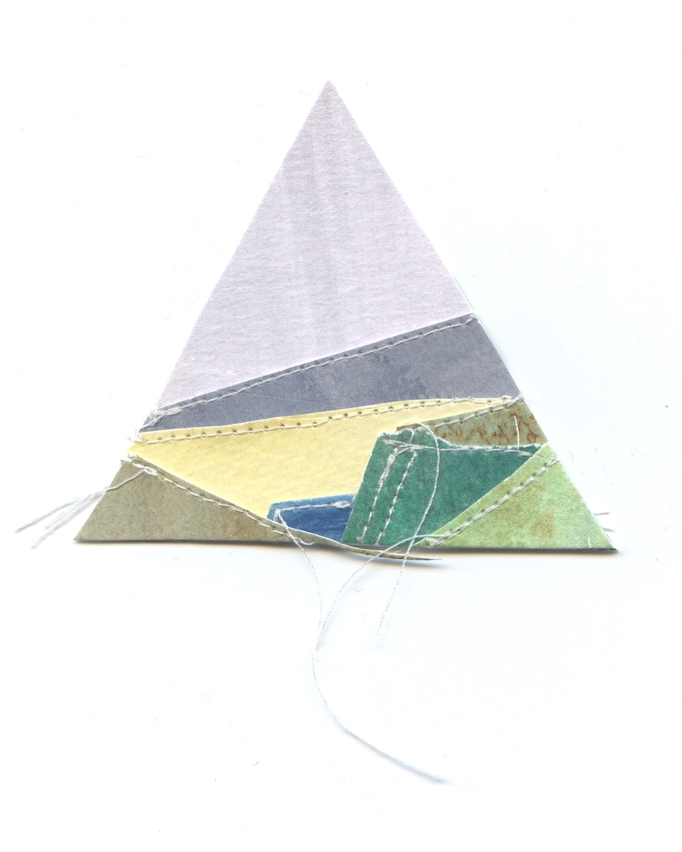 Triangular fabric patch with geometric pattern on a white background
