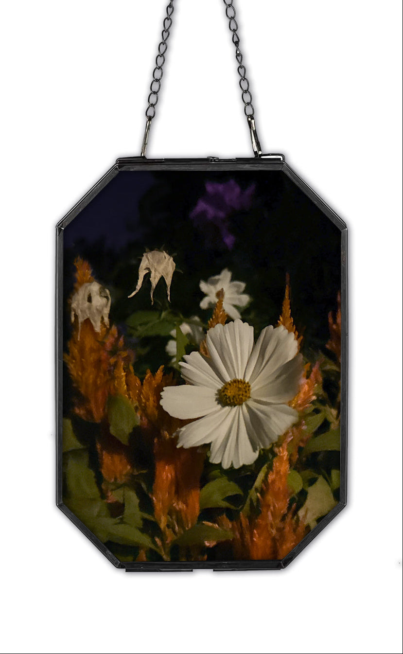 Decorative wall hanging with floral design and chain on a white background