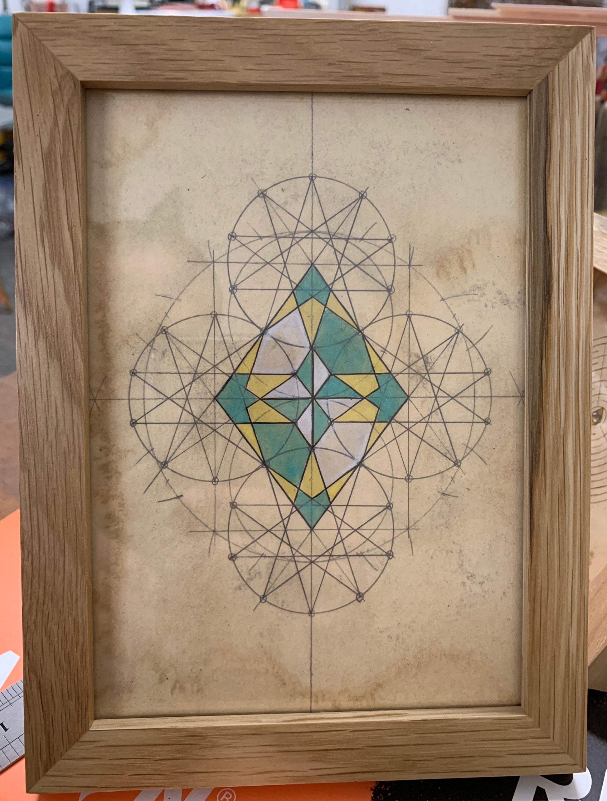 Geometric design on paper inside a wooden frame