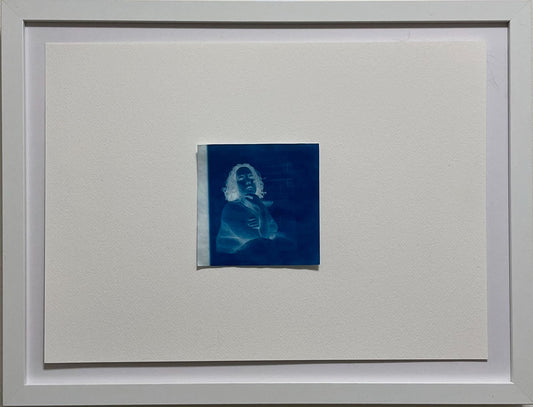 Framed artwork on a plain wall