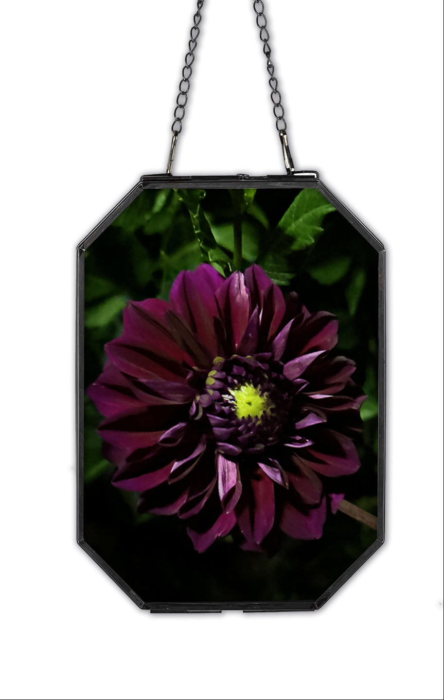 Decorative wall hanging with a purple flower design on a white background