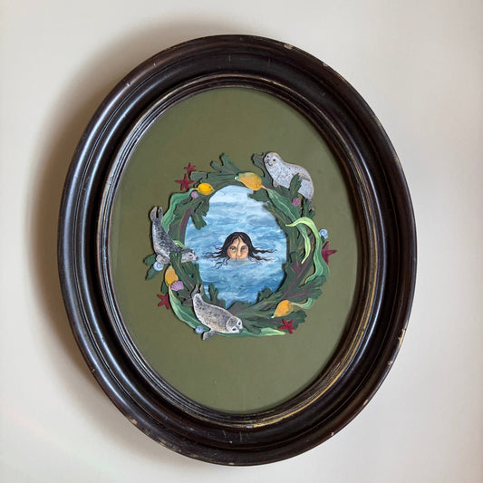Decorative circular piece with a central design, framed in black on a light background