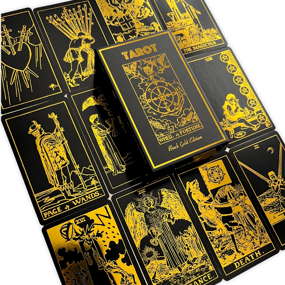 Black tarot cards with gold illustrations on a white background