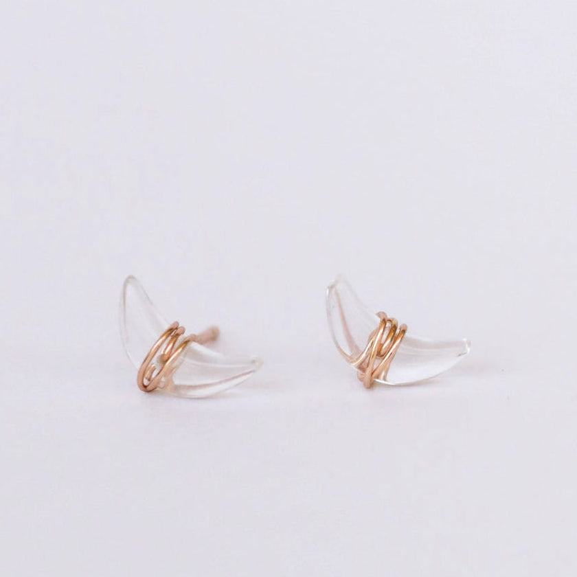 Pair of quartz crescent moon earrings on a light gray background