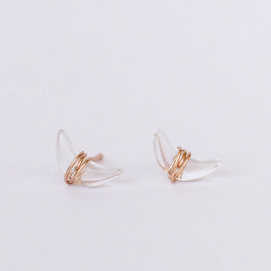 Pair of quartz crescent moon earrings on a light gray background