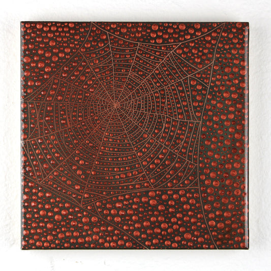 A square canvas wall art print featuring a detailed spiderweb design over a textured background of red and black dots, displayed against a white textured wall.