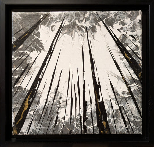 Abstract art piece with black, white, and gold elements in a black frame.